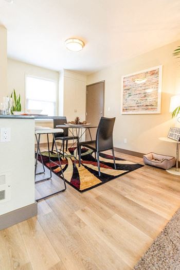 a living room and dining room with a table and chairs